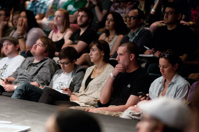 Attendees listening intently to their peers giving talks